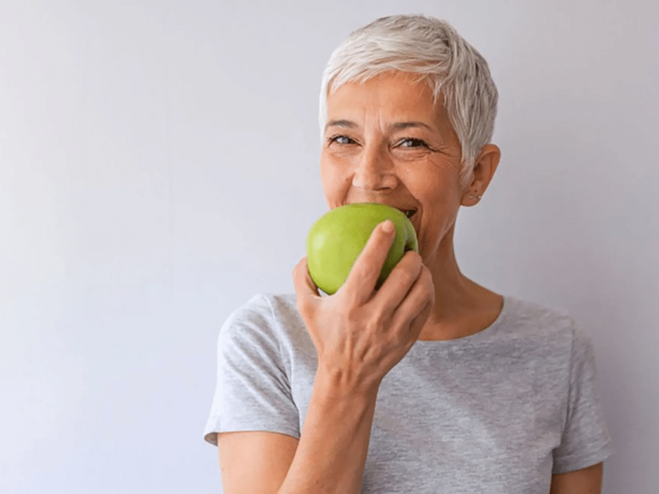 Longevity woman eating an apple 1
